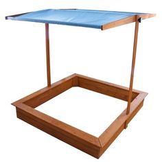 a wooden table with a blue cover on it's top and two legs in the middle