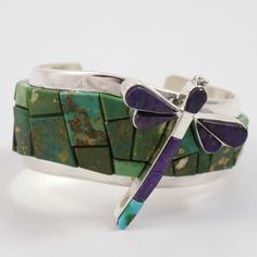 Sterling Silver Cuff Bracelet featuring a Cobbled Inlay Design using Natural Fox Turquoise from Nevada. This bracelet includes a dragonfly with inlaid purple sugilite and natural Kingman turquoise from Arizona.1.25” Cuff Width (1.875” width including the dragonfly)5.5” Inside Measurement, plus 1” opening(6.5" Total Circumference - Medium) Inlay Jewelry Dragonfly, Inlay Design, Sterling Silver Cuff Bracelet, Kingman Turquoise, Sterling Silver Cuff, Silver Cuff Bracelet, Silver Cuff, Nevada, Cuff Bracelet