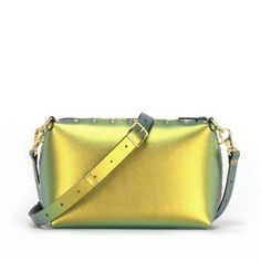 Small crossbody bag with a zipper top to securely hold your stuff, thoughtfully crafted from super-soft and easily cleanable iridescent gold vegan leather. This handbag features an interior and exterior pocket (each sized to fit a large phone) and shoulder/crossbody strap that adjusts from to 37" to 66" (94 - 168 cm) to fit all body types. All Mohop handbags are handmade in our workshop in northern Illinois from animal-friendly materials and American-made hardware.  100% Vegan!  Measurements:Hei Green Clutch Bag With Zipper Closure, Gold Crossbody Satchel With Zipper Closure, Gold Crossbody Shoulder Bag With Zipper Pocket, Green Crossbody Pouch, Gold Leather Bag With Zipper Pocket, Rectangular Evening Shoulder Bag With Zipper Pocket, On-the-go Crossbody Satchel With Zipper Pouch, Modern Clutch Bag With Zipper Closure, Zipper Pouch Crossbody Satchel