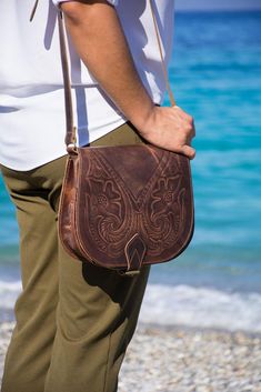 !FREE 4 days delivery with DHL express shipping! Please add a note with your phone number at checkout. Women's leather tooled crossbody bag made by 100% genuine leather. Handcrafted in Greece. Large size. Leather crossbody satchel bag with adjustable strap. Shoulder saddle bag. Two internal compartments, plus a zipped pocket. It fits all everyday essentials. Antique brown color with embossed floral pattern. Please note that due the fact that each bag is handcrafted by handpicked cow hide, they m Saddle Bag Purse, Tooled Leather Bag, Tooled Leather Purse, Pattern Bag, Bag Flower, Brown Crossbody Bag, Leather Saddle Bags, Brown Crossbody, Crossbody Bags For Women