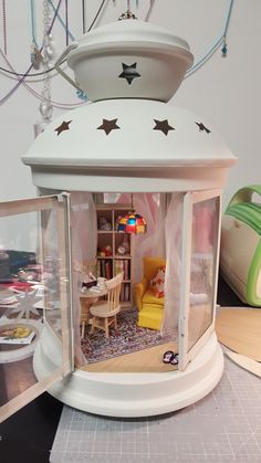 a doll house with furniture and accessories in it's display case on top of a table