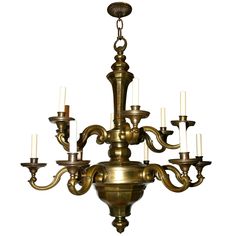 an antique brass chandelier with six candles