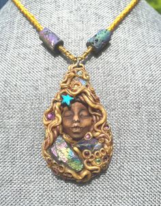 This little dreamer holds a lot of sparkle in her locks. Tiny crystals are all through this piece. The necklace is woven to 17" and held by clasp.  3 Druzy Agate points are centered in the pendant itself and two barrel druzy beads and woven into the necklace. Unique and one of a kind gift. Comes gift wrapped  and boxed for safe shipping.  Druzy stones are wonderful to help us amplify our self healing abilities. These beautiful stones bring heightened intuition and balance to our spiritual selves. We can all use a little more unconditional love for ourselves and others in a world gone bi polar ️.. this pendant has a peaceful and tranquil feeling about it. This talisman was charged with the full spectrum solfeggio frequencies from bottom to top. Much love to who ever this piece will go to 🤗 Handmade Goddess Pendant Necklace, Handmade Mystical Necklaces, Handmade Magical Pendant Necklace, Handmade Magical Necklaces For Festival, Beaded Bohemian Polymer Clay Necklaces, Bohemian Beaded Polymer Clay Necklaces, Handmade Adjustable Mystical Crystal Necklace, Mystical Handmade Adjustable Crystal Necklaces, Mystical Handmade Adjustable Crystal Necklace