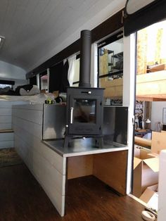 a stove sitting inside of a kitchen next to a window