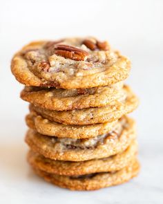 a stack of cookies with pecans on top