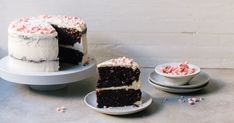 two pieces of cake on plates with one slice cut from it and the other half eaten