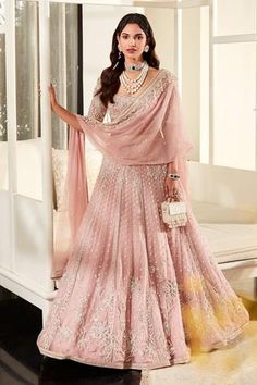 Light onion pink lehenga with all-over embroidery and 3D floral motifs. Comes with embroidered blouse, dupatta and belt.
Component: 4
Pattern: Embroidery
Type Of Work: Sequin, Pearl, Cutdana and 3D Floral Motif
Neckline: Scoop
Sleeve Type: Half
Fabric: Net
Color: Pink
Other Details: 
Belt with bead hangings
Dupatta with embroidered border
Low back
Closure: Back hook
Note: Bag carried by the model is not for sale
Occasion: Bride - Aza Fashions Light Pink Lehenga, Indian Garments, Ruffle Dupatta, Desi Attire, Onion Pink, Ridhi Mehra, Net Blouse, Organza Lehenga, Net Blouses