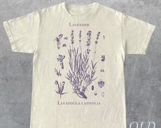 Vintage Lavender 90s Graphic T-Shirt, Retro Lavender Unisex Adult Shirt, Wildflowers Nature Shirt, Botanical Shirt, Relaxed Cotton Shirt. A shirt is a multipurpose upper-body item that is frequently composed of cloth. It offers both comfort and style and is available in a variety of designs, colors, and textiles. Shirts are a wardrobe staple for every occasion since they can be dressed up with pants or down with jeans. #Shirt #Snorider Vintage Lavender, Botanical Shirt, Nature Shirts, Mens Long Sleeve Tee, Adulting Shirts, Summer Shirts, New Outfits, Fashion Games, Cotton Shirt