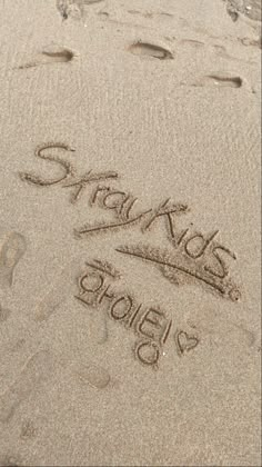 someone wrote their name in the sand at the beach