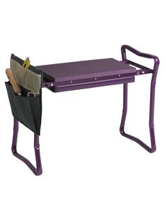 a purple desk with two folding chairs and a knife holder on it's side