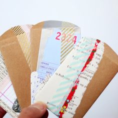 a person holding several different types of tickets in their hands, with the number twenty on them