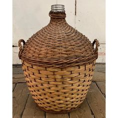 a large wicker basket sitting on top of a wooden floor