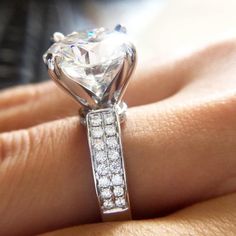 a woman's hand with a diamond ring on it