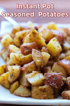 a white plate topped with potatoes on top of a wooden table and text overlay that reads instant pot seasoned potatoes