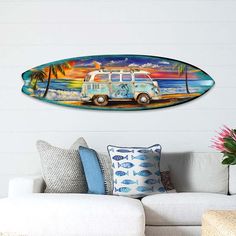 a surfboard is hanging on the wall above a couch