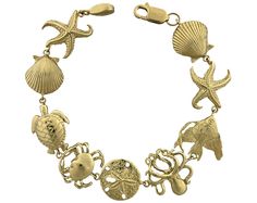 a gold bracelet with an octopus, starfish and other sea creatures