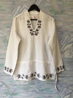 "Women's White Linen Blouse Long White Shirt Embroidered White Shirt Extra Large Size Blouse Shirt Dress Estimated size: F 44/ UK 16/ D 42/ NL 42/ Material: 100%Linen Measurements: (lying flat) Length - 28,3\" / 72 cm Shoulders: 16.5\" / 42 cm Bust: 21.6\" / 55 cm Waist - 21.6\" / 55 cm Sleeve: 23,6\" / 60 cm Please check measurements to insure a proper fit. Remember to allow yourself some extra room for movement. You can compare these with something from your closet that fits you well. This blo White Embroidered V-neck Kurta, Traditional V-neck Blouse With Embroidered Hem, Casual Long Sleeve Embroidered Kurta, White Summer Shirt With Chikankari Embroidery, White Long Sleeve Bohemian Shirt, White Cotton Tunic Shirt, Spring Long Sleeve Blouse With Motif, Spring Motif Long Sleeve Blouse, White Casual Tunic With Floral Embroidery