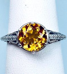 Yellow Citrine Ring- Design #167 Choose: Natural or Simulated Made To Order Here we have an Art Deco/Edwardian inspired ring in sterling silver filigree with a Yellow Citrine gemstone (Choose your gemstone- Natural or Simulated) solitaire. This full cut round cut gemstone is 8mm in diameter. The setting is 9mm NS on the finger. The inside of the band is marked 925 for sterling. Notice the beautiful etched royal design of the silver filigree setting. A gift ring box is included and all rings are Cut Garden, Champagne Ring, Yellow Citrine Ring, Luxury Jewelry Box, Antique Jewelry Rings, Order Design, Royal Design, Gold Filled Ring, Yellow Citrine