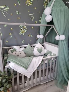 a baby's room with a canopy bed and green decor on the walls,