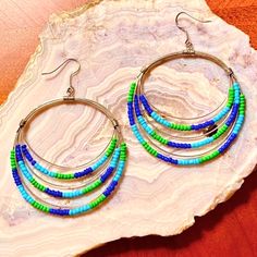 Gorgeous Beaded Silver Hoop Earrings In Multi-Layered Light Turquoise, Cobalt Blue & Spring Green Beads. Strikingly Beautiful, Unique & Lightweight On The Ear. The Flattering Boho Design Is Sure To Become Your Favorites & Looks Fantastic With Blue Jeans, Jean Shorts & Skirts. It Also Looks Wonderful With More Structured Styles When You Want To Make A Strong Statement. Approx. 3” Long, 2 1/8” Wide. Brand New, Never Worn. Nwot Bohemian Large Beads Hoop Beaded Earrings, Unique Multicolor Hoop Earrings With Round Beads, Bohemian Blue Hoop Earrings With Colorful Beads, Blue Beaded Metal Hoop Earrings, Bohemian Large Beads Multicolor Hoop Earrings, Anthropologie Jewelry, Blue Spring, Shorts Skirts, Green Beads