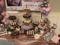 a table topped with lots of cakes and cupcakes