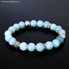 "❖ AQUAMARINE: Natural 8mm gemstone ❖ ♥ Cleansing ♥ Meditation ♥ Serenity ♥ Peace ♥ Prophecy ♥ Inspiration ♥ Tranquility ♥ Inner power strength ♥ Soothing ♥ Calming ♥ Safe travel on water ❖ SPACERS & SILVER BEADS : Antique pewter charms made in USA. ❖ Durable Elastic Stretch Cord. ❖ The gemstones are natural, so you may see some variations. ❖ Your purchase will arrive attractively packaged and ready to give. ❖ Size ❖ Women Small: Fits 5.5\" - 6\" Women Medium: Fits 6\" - 6.5\" Women Large: F Aquamarine Bracelet Beads, Fertility Bracelet, Beaded Braclets, Howlite Bracelet, Aquamarine Bracelet, Bracelets Design, Aquamarine Beads, Beaded Necklace Diy, Diffuser Bracelets