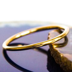 "This Gold stacking ring is entirely hand-made & mixes well with most of the items in our store. * This listing is for (1) one ring. * Made with: 16g (1.29 mm) 12k Yellow Gold-filled wire. * When stacked, they measure at about 7 rings per half inch. * We do make 1/2 & 1/4 sizes, just leave a note with your size preference. * All of our items are entirely hand crafted and have a standard processing time of 3-5 Business days to make the order. * Items are processed in the order they are pu Hoop Rings With Tarnish Resistance As A Gift, Hypoallergenic 14k Gold Hoop Rings, Gold Hypoallergenic Rings With Round Band, Minimalist Bangle Rings For Gifts, Hypoallergenic Gold Rings With Round Band, Yellow Gold Hoop Rings As Gift, Hypoallergenic Yellow Gold Stackable Rings, Hypoallergenic Yellow Gold Toe Ring, Stackable Yellow Gold Couple Rings