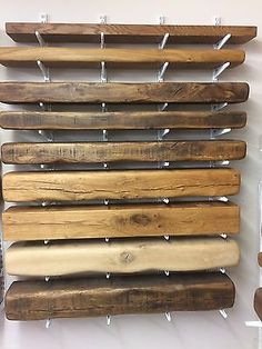 a wall mounted wooden rack holding baseball bats