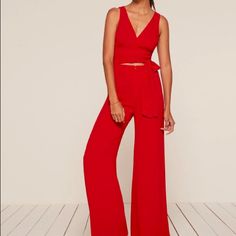 Jumpsuits Are Great Because They're A Top And Pants All In One - Less Work For You. This Is A Wrap Front Jumpsuit With A Slightly Cropped Top And A Center Front Zipper At The Waist. Chic Red V-neck Sets, Red Chic V-neck Sets, Red V-neck Chic Sets, Chic Red Sets For Night Out, Chic Red Wide Leg Pantsuit, Spring Red Pantsuit For Night Out, Red Wide-leg Pantsuit For Party, Red Pantsuit For Spring Night Out, Red Wide Leg Pantsuit For Party