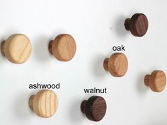 four different types of wood knobs on a white surface with the words oak, ashwood, walnut and oak