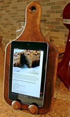 a tablet sitting on top of a wooden stand