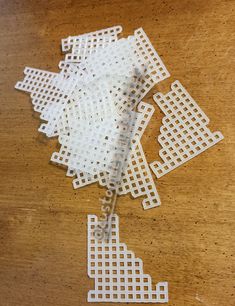 several pieces of white plastic sitting on top of a wooden table