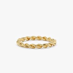 a gold braid ring on a white background