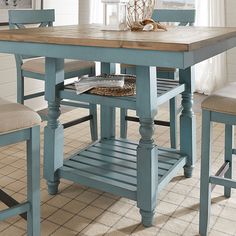 a dining room table with two chairs and a basket on the top of one chair