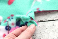 someone is sewing something on the side of a piece of fabric that has been sewn together