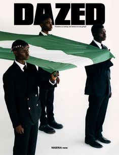 two men in suits are holding a green and white flag with the word dazed on it