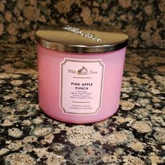 a pink candle sitting on top of a counter