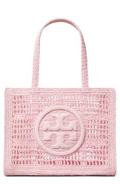 Crocheted raffia and a wrapped double-T logo add a breezy flourish to your on-the-go style when you step out the door with this whimsical tote. Open top Top carry handles Structured silhouette with flat base for stability Paper straw with raffia and polyurethane trim Imported Designer Beach Bags, Preppy Purses, Rush Bag, Pink Beach Bag, Pretty Purses, Pink Shoulder Bags, Pink Bags, Tory Burch Ella, School Bag Essentials