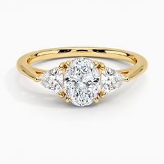 three stone oval diamond ring in yellow gold