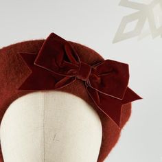 Russet red French beret hat with a russet velvet ribbon bow.A machine made wool felt beret hat customised with a handmade russet velvet ribbon bow. This russet red beret with a bow is the perfect winter accessory. The velvet ribbon bow is a timeless decoration making this is a classic design, great for wearing every day.This russet beret is also available with a black velvet ribbon bow.These berets are approximately 25cm (10 inches) in diameter and are a ladies one size. They will comfortably fi Red Flat Cap Beret For Fall, Adjustable Red Winter Beret, Red Adjustable Winter Beret, Vintage Red Hat For Fall, Vintage Red Flat Cap, Velvet Ribbon Bow, Red Berets, Felt Beret, French Beret Hat