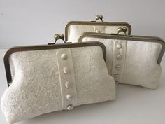 two white purses sitting next to each other