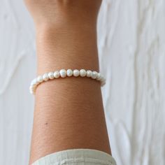 Make an Everyday Statement with Our Elegant Pearl Bracelet - A Timeless Essential for Effortless Elegance: Hypoallergenic, Tarnish-Free, and Water-Resistant for Unmatched Quality. Introducing our exquisite Everyday Statement Pearl Bracelet, a true embodiment of modern style and sophistication. This stunning bracelet is designed to gracefully elevate your everyday look, making it a must-have accessory that effortlessly stands out. Crafted with meticulous attention to detail, our Everyday Statemen Adjustable Classic Pearl Bracelet For Everyday, Classic Adjustable Pearl Bracelet, Delicate Adjustable Hypoallergenic Bracelets, White Jubilee Stretch Bracelet, Flexible Hand-strung Bracelets, White Single Strand Bracelet As A Gift, White Single Strand Bracelet Gift, Delicate White Hand-strung Bracelets, Classic Adjustable Hypoallergenic Pearl Bracelet