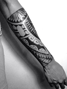 a man's arm with an intricate tattoo design on the forearm and hand, in black and white