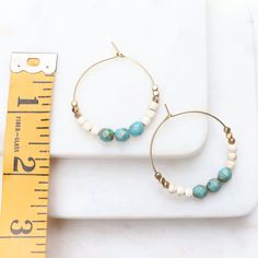 Pretty hoop earrings with turquoise and gold colors. These boho hoop earrings are colorful and pretty, and with popular turquoise, off white and golden brass beads will compliment most outfits. Medium sized hoop diameter is about an inch and a half. See final images for color choice options available in shop at in the hoop earrings section: www.etsy.com/shop/heatherberry Your new earrings will ship quickly in a little gift box. Find more awesome designs here: www.etsy.com/shop/heatherberry http: Turquoise Round Bead Earrings For Everyday, Turquoise Dangle Hoop Earrings, Everyday Turquoise Round Bead Earrings, Everyday Turquoise Beaded Earrings, Blue Bohemian Hoop Earrings For Everyday, Turquoise Hoop Jewelry, Nickel-free Turquoise Hoop Jewelry, Turquoise Hoop Beaded Earrings For Jewelry Making, Turquoise Beaded Earrings With Small Hoop