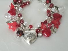 "Red Heart Charm Bracelet This beautiful bracelet has glass pearl beads, red glass beads, silver plated bead caps, lucite flower beads, sterling silver plated chain and pewter silver charms. 7\" long can be adjusted to 9\". Silver plated lobster clasp." Cheap Vintage Jewelry For Valentine's Day, Valentine's Day Beaded Metal Jewelry, Red Costume Jewelry Bracelets As Gift, Elegant Handmade Red Charm Bracelet, Silver Bracelet For Valentine's Day, Elegant Red Handmade Charm Bracelet, Red Metal Heart Bracelet As Gift, Red Metal Heart Bracelet Gift, Vintage Bracelet Jewelry For Valentine's Day