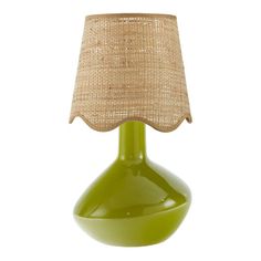 a green lamp with a burlap shade on it