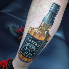 a man's leg with a bottle of whiskey on it