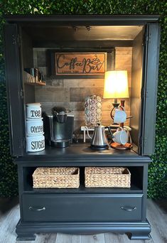 a coffee bar with two wicker baskets under the shelf and a lamp on top