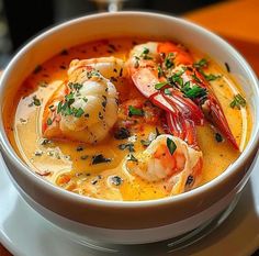 a white bowl filled with soup and shrimp