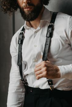 Suspenders are a stylish and unusual alternative to a traditional belt. They are made of durable and high-quality genuine leather, which will make your image more presentable. Leather suspenders will become the highlight of your wardrobe. Laconic metal elements and buckles are harmoniously combined with leather. The accessory will look appropriate in any setting. It will make you stand out from the crowd and help create a gallant image. Suspenders made of genuine leather are an ideal accessory f Black Leather Suspenders, Traditional Belt, Men's Suspenders, Hipster Gifts, Suspenders Men, Leather Suspenders, Formal Accessories, Style Formal, Groomsmen Gift